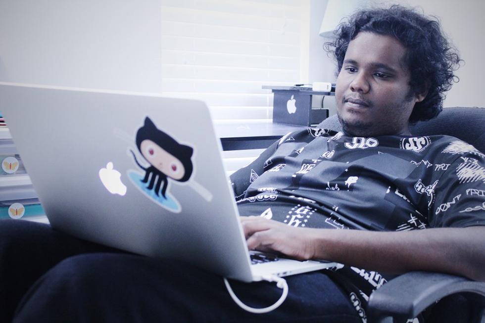 programmer writing code on a laptop