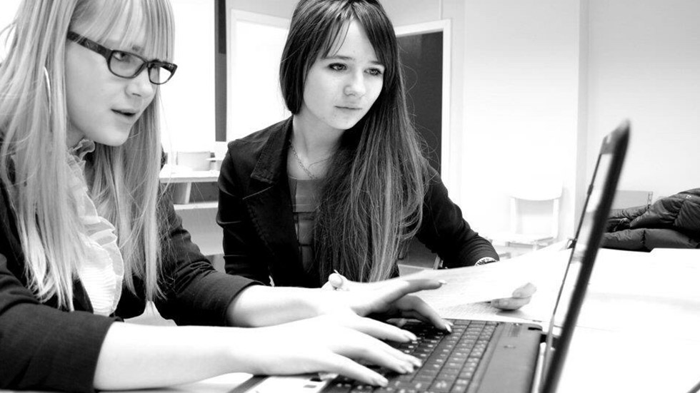 engineers looking at code on a laptop
